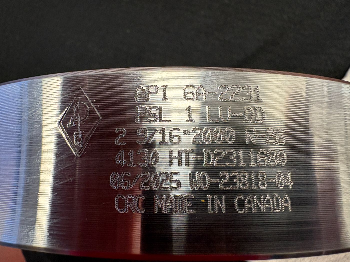 Stamped markings: API 6A-2231, PSL 1 LU-DD, 2 9/16 inch 2000 R-26, 4130 HT-D2311680, CRC Made in Canada