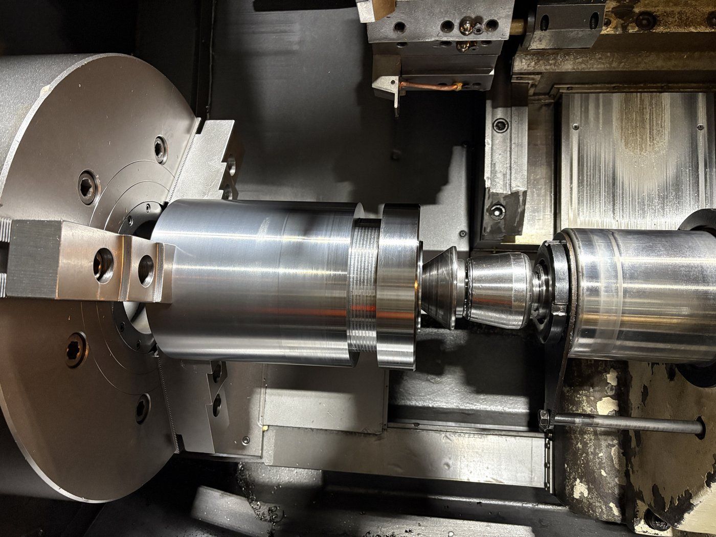 Spool adaptor being turned from a single body on a CNC lathe